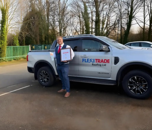 FlexiTrade Roofing owner beside their branded pickup truck