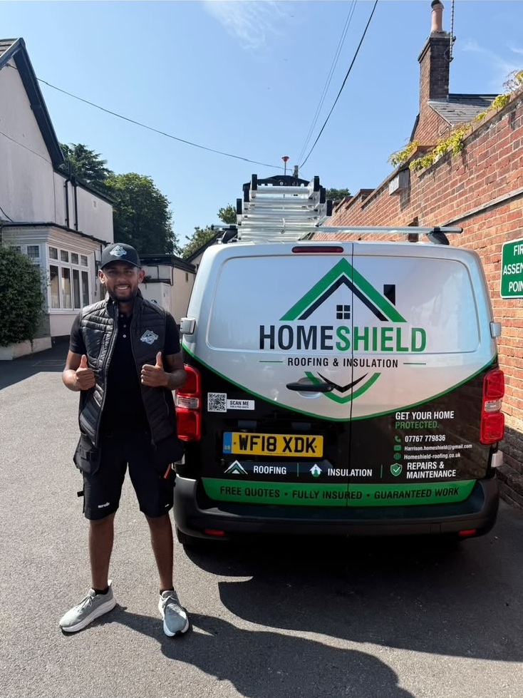 Homeshield Roofing & Insulation team member beside their branded van